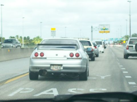 2003 Mercury Marauder - A line of cars on the highway, with a silver Nissan Skyline GT-R in the foreground.
