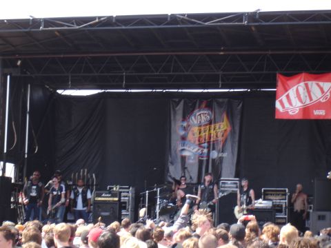 1992 Ford F-150 - Outdoor concert stage with band performing, Vans Warped Tour branding.