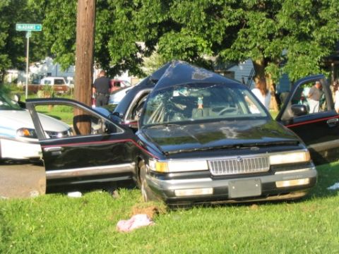 1999 Ford Crown Victoria - This 1999 Ford Crown Victoria sustained significant damage in an accident, with its windshield shattered and hood deformed.