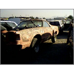 1973 Ford Ranchero - This vehicle appears to be in a junkyard, with multiple other vehicles visible in the background.
