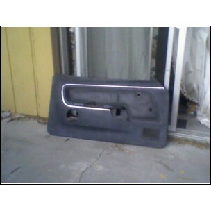 1973 Ford Ranchero - A single car door panel is shown leaning against a wall.