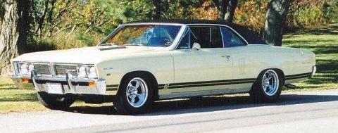 1991 Ford Bronco - Cream 1967 Chevrolet Chevelle SS coupe with black vinyl top and side stripes parked on a road.