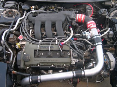 1997 Ford Probe - Engine bay details show a V6 DOHC 24-valve engine with aftermarket modifications and Mazda branding.