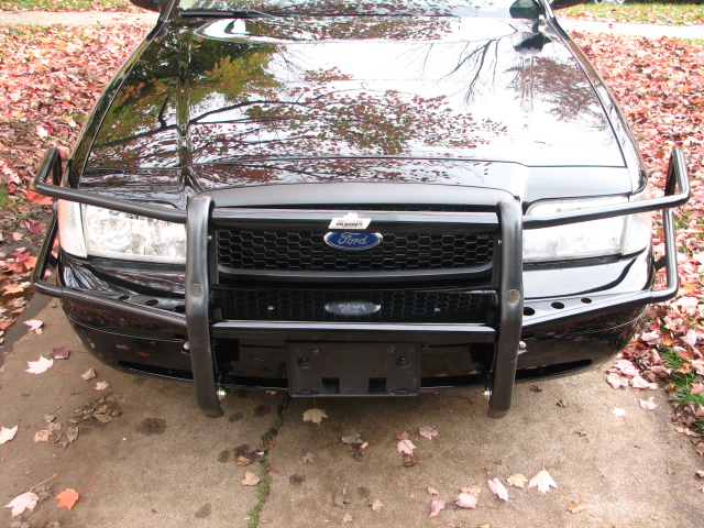 Black 2000 Ford Crown Victoria with a heavy-duty push bar, front view