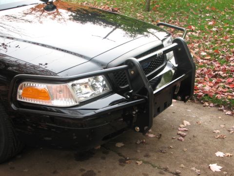 2000 Ford Crown Victoria - This black 2000 Ford Crown Victoria is equipped with a heavy-duty push bumper and a light bar on the roof.