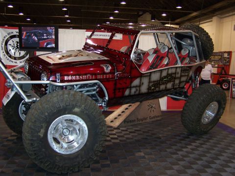 1989 Ford Bronco - Customized Jeep with "Bombshell Betty" graphics and extreme off-road tires on display.