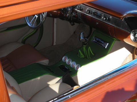 1998 Ford Crown Victoria - View through a window of a custom interior with green-and-white upholstery, a chrome steering wheel and a row of underdash gauges.