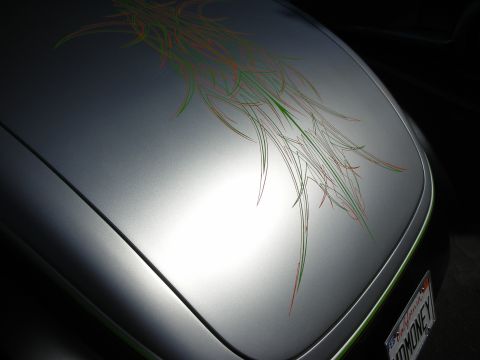1998 Ford Crown Victoria - silver custom hood decorated with an orange-and-green pinstripe scroll graphic, with a HOTMONEY plate below.