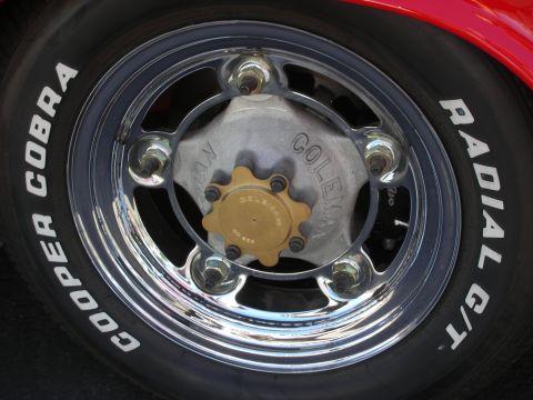 1998 Ford Crown Victoria - Polished five-lug wheel wearing a Cooper Cobra Radial G/T white-letter tire, with a gold-anodized center hub.
