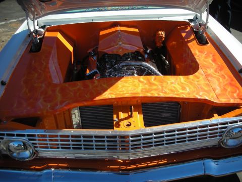 1998 Ford Crown Victoria - Open engine bay of a custom car finished in orange airbrushed real-flame paint surrounding a chrome detailed V8.