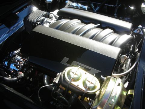 1998 Ford Crown Victoria - modern LS-style fuel-injected V8 engine with a sculpted intake manifold marked LS7 and gold-cadmium accessories.