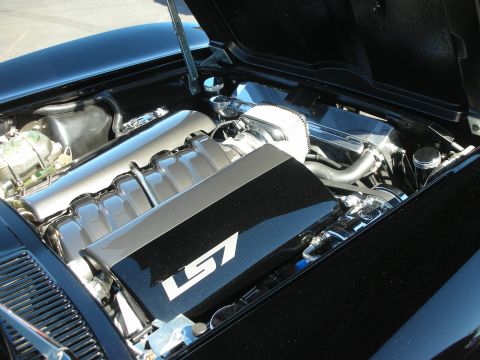 1998 Ford Crown Victoria - detailed engine bay showing a polished V8 with a black LS7-labeled coil cover, chrome accents, and stainless plumbing.