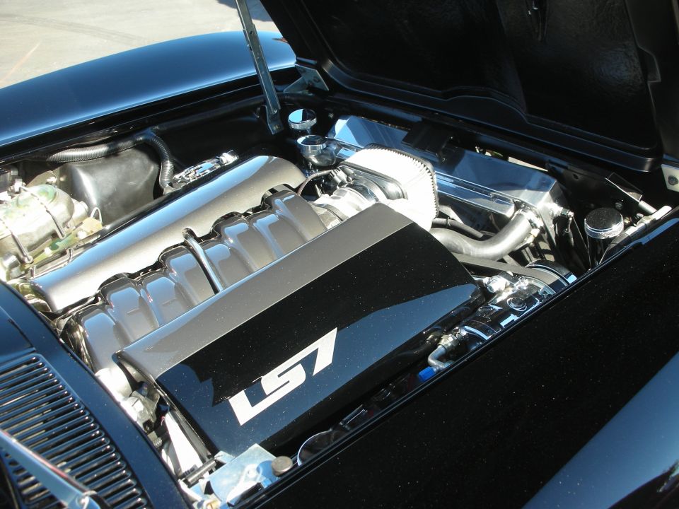 Engine bay with polished LS7 V8 and black coil cover at center