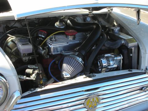 1998 Ford Crown Victoria - transverse four-cylinder engine in a Mini bay, fitted with a polished cone air filter, red cam cover, and chrome alternator.