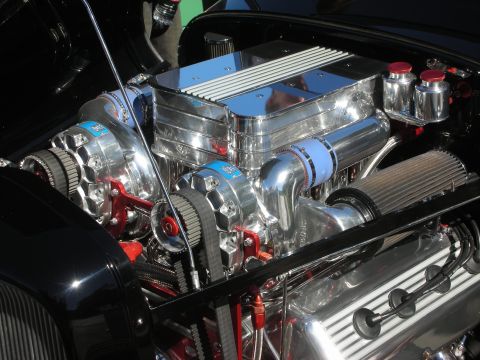 1998 Ford Crown Victoria - heavily chromed supercharged V8 hot-rod engine bay featuring polished blower components and braided lines.
