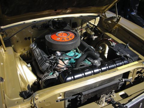 1998 Ford Crown Victoria - Mopar V8 engine bay in a gold car, topped by a round black air cleaner with an orange MAGNUM decal.