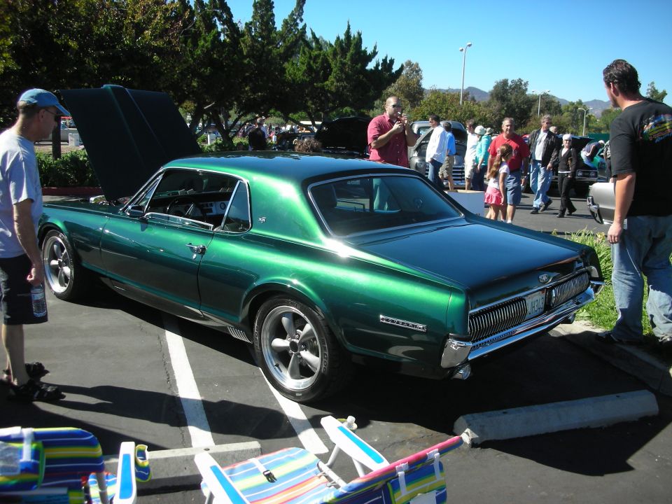 Rear three-quarter of dark green Mercury Cougar coupe at car show