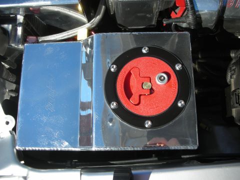 1998 Ford Crown Victoria - polished metal cover housing a red rotary battery cutoff switch mounted in a custom engine bay.