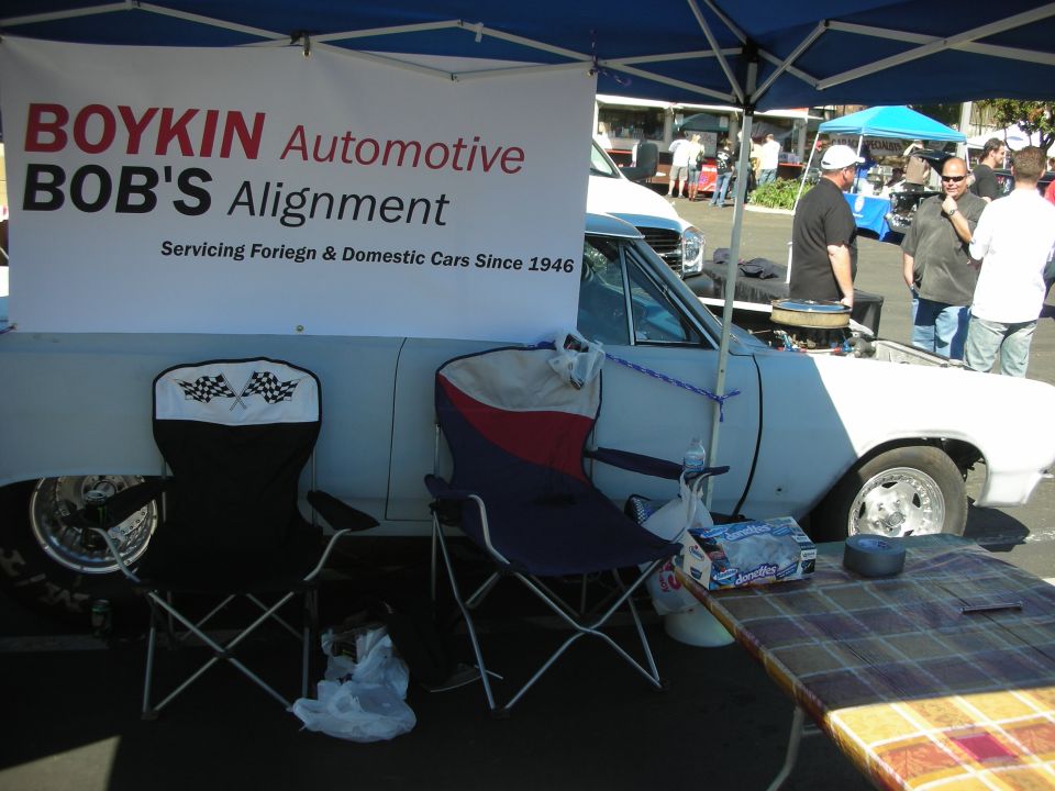 Boykin Bob's Alignment banner over a white car under a canopy