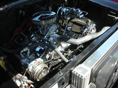 1998 Ford Crown Victoria - chromed V8 engine with a round chrome air cleaner fills a polished classic-car engine bay.