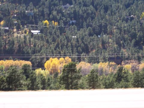 1972 Ford Ranchero - A scenic view of houses on a hillside surrounded by evergreen and autumn foliage.