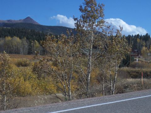 1972 Ford Ranchero - A scenic view of a mountain range with fall foliage and a paved road.