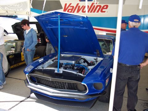 1971 Ford Mustang - Blue 1969 Ford Mustang with hood open, parked next to another race car.