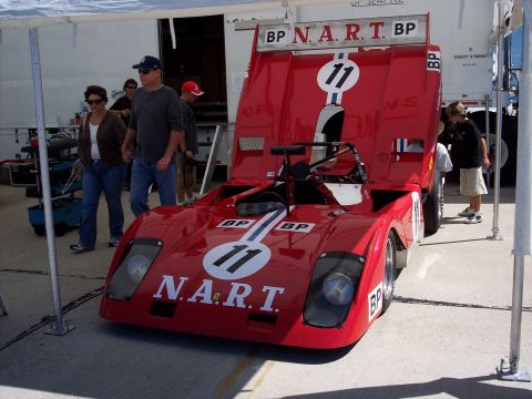 1971 Ford Mustang - A red N.A.R.T. race car with number 11 is parked under a tent.
