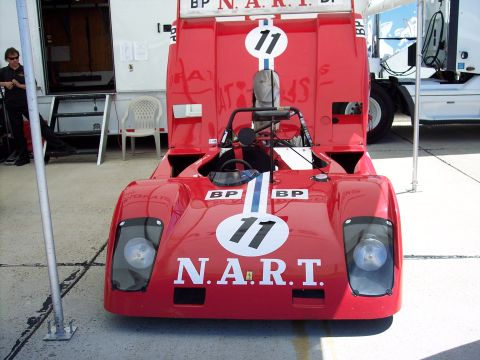 1971 Ford Mustang - A red race car with BP and N.A.R.T. branding is parked outdoors.