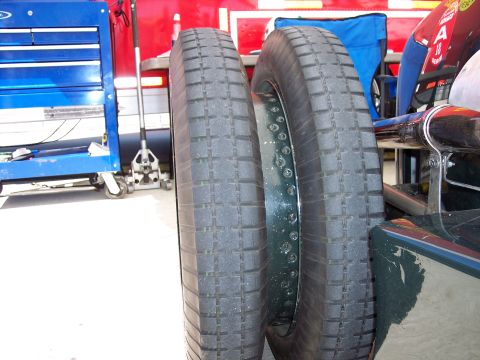 1971 Ford Mustang - Close-up of two tires and a toolbox, with a red background.
