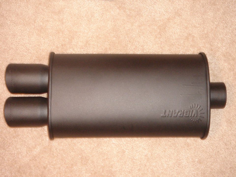 Black Vibrant performance muffler with dual outlets on carpet