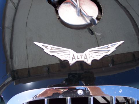 1971 Ford Mustang - A chrome winged badge with the word 'ALTA' is visible on the hood of a dark vehicle.