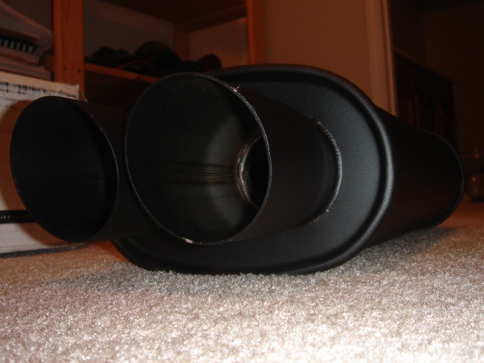 Black plastic intake ducting parts with round openings on carpet