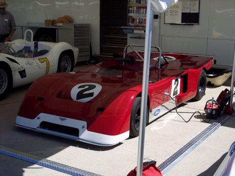 1971 Ford Mustang - A red race car with number 2 is parked next to another white race car.