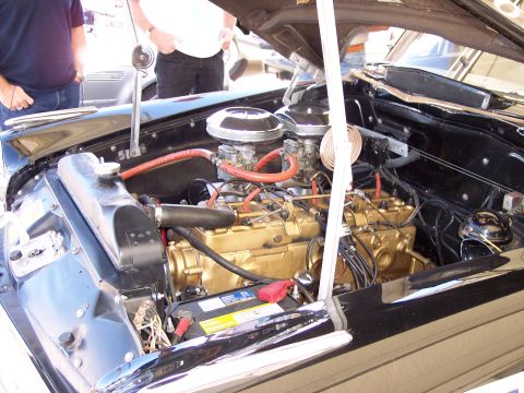 1971 Ford Mustang - Close-up of a classic car's engine bay, a V8 engine with dual carburetors.