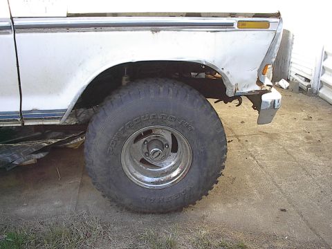 1978 Ford Bronco - Close-up of a 1978 Ford Bronco's side, highlighting the fender and wheel assembly.