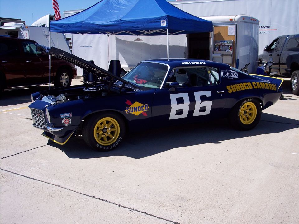 Dark blue race car with yellow wheels and number 86. "SUNOCO CAMARO" is written on the side