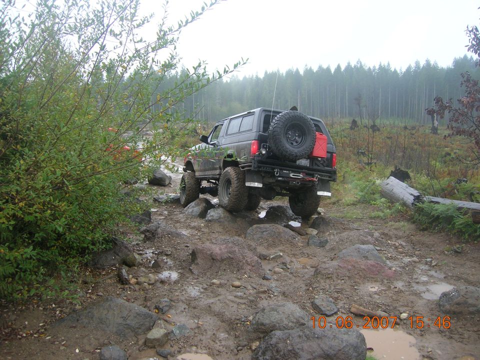 1996 Ford Bronco on a rocky trail, rear view