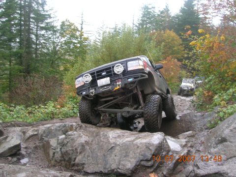 1996 Ford Bronco - A modified 1996 Ford Bronco tackles a challenging rocky off-road course during an autumn excursion.