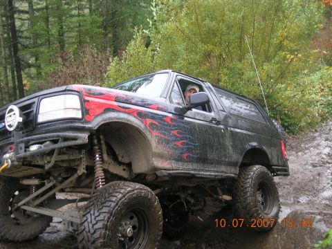 1996 Ford Bronco - This modified 1996 Ford Bronco navigates a challenging off-road course on a cloudy day.