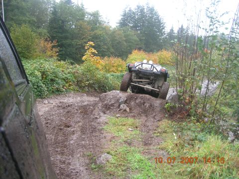 1996 Ford Bronco - An off-road vehicle tackles a challenging muddy incline on a wooded trail, captured on October 7, 2007.