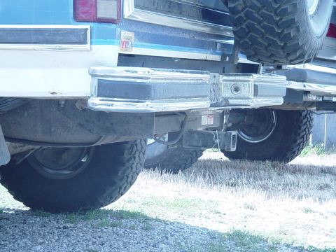 1985 Ford Bronco - The rear bumper and large tires of a 1985 Ford Bronco are visible in this registry photo.