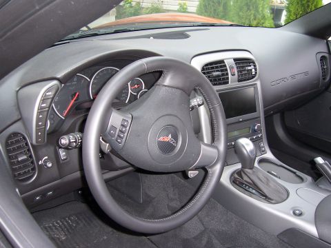 1996 Ford Bronco - Interior view of a Corvette, showing the dashboard, steering wheel, and gear shifter.