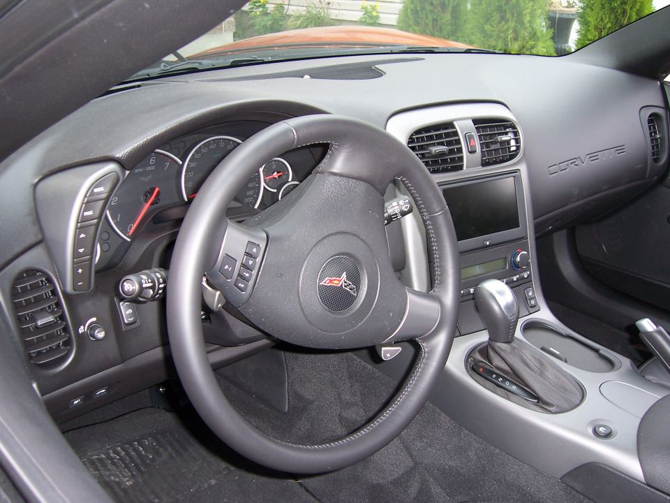 C6 Corvette black interior: steering wheel, gauges, nav screen, automatic shifter