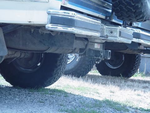 1985 Ford Bronco - Close-up of the rear bumper and tires on a 1985 Ford Bronco.