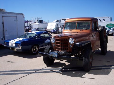 1971 Ford Mustang - A blue 1965 Ford Mustang Shelby GT350 is parked next to a custom Jeep.