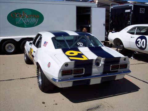 1971 Ford Mustang - Rear view of a vintage race car with racing stripes and number 67.