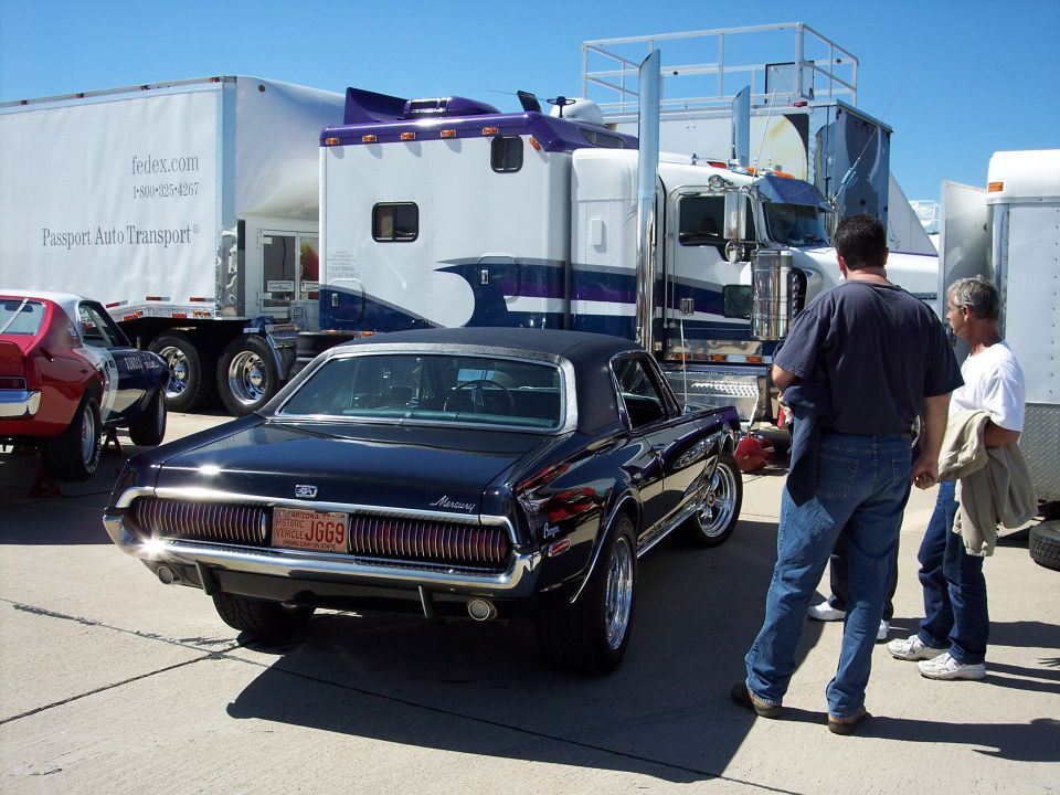 Dark blue Mercury Cougar rear view, chrome bumper, vertical taillights, license plate JGG69