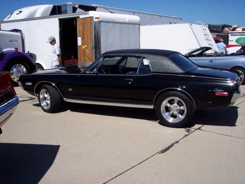 1971 Ford Mustang - Side view of a black 1969 Mercury Cougar XR7 with aftermarket wheels.
