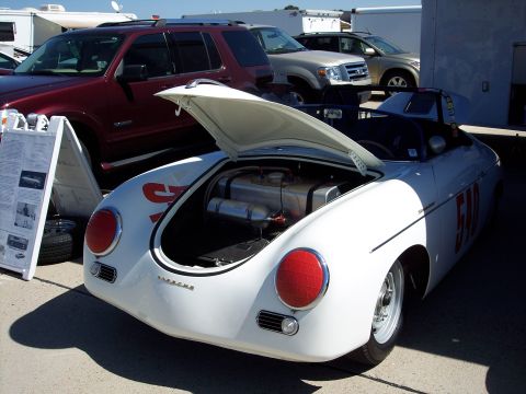 1971 Ford Mustang - A white Porsche 356 roadster is displayed with its rear hood open, revealing its fuel system components.